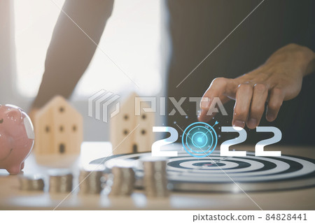 2022 new year and Targeting the new business concept, Businessman use fingers touch dart to virtual target dart board,Executive marketing, investment goal and target for business investment. 84828441
