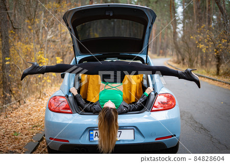 Sexy, flexible woman on the heels with car on the road doing stretching . Concept of yoga and healthy lifestyle Sexy, flexible woman on the heels with car on the road doing stretching . Concept of yoga and healthy lifestyle 84828604