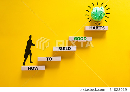 Build good habits symbol. Wooden blocks on beautiful yellow background, copy space. Words 'How to build good habits'. Businessman icon. Build good habits concept. Copy space. 84828919