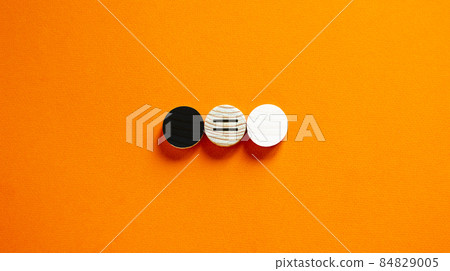 Racial equality concept. Black and white wood circles  on beautiful orange background. Copy space. 84829005