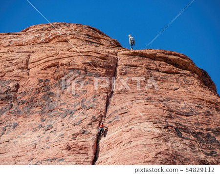 People doing rock climbing sports People doing rock climbing sports 84829112