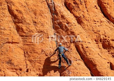 People doing rock climbing sports People doing rock climbing sports 84829145