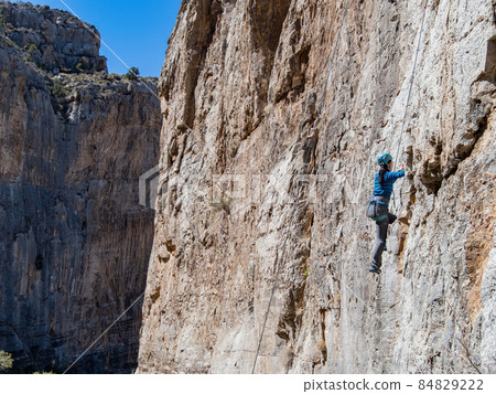 People doing rock climbing sports People doing rock climbing sports 84829222