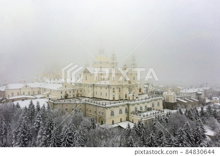Pochaev Lavra in Ukraine at the winter with fog aerial panorama view 84830644