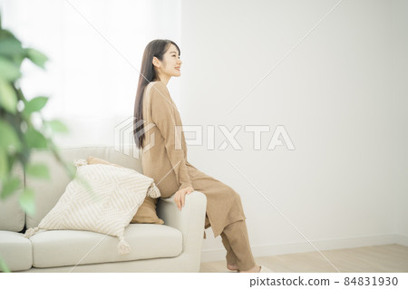 Female sitting on a sofa helicopter 84831930