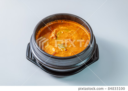 Korean food marbled cheonggukjang stew cooked in a black pot 84833100