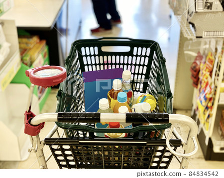 Shopping cart waiting for turn in front of the cash register 84834542