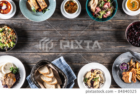 Top view of assortment of food served on a rustic wooden table with copy space Top view of assortment of food served on a rustic wooden table with copy space 84840325