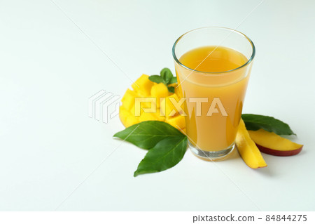 Mango juice and fruit on white background Mango juice and fruit on white background 84844275