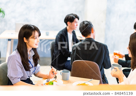 An office worker having lunch in a bright employee cafeteria An office worker having lunch in a bright employee cafeteria 84845139