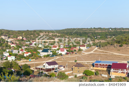 Crimean landscape with rural houses in a valley 84845909