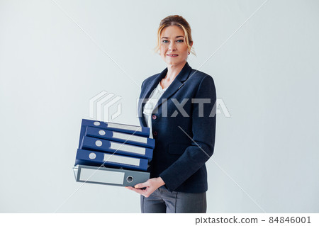 woman 40 years old with folders for papers in a white office woman 40 years old with folders for papers in a white office 84846001
