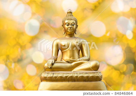 Beautiful of Ancient Golden Buddha statue on light golden yellow bokeh background,Thailand holiday concept 84846864