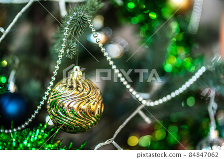 Merry x-mas,Close up of Colorful balls ,gifts box and Christmas greeting picture parcel decoration on Green Christmas tree background Decoration During Christmas and New Year. Merry x-mas,Close up of Colorful balls ,gifts box and Christmas greeting picture parcel decoration on Green Christmas tree background Decoration During Christmas and New Year. 84847062