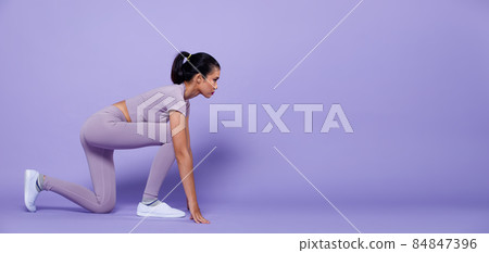 Full length Asian slim Fitness woman exercise warm up stretch spring jumps legs, peri purple Full length Asian slim Fitness woman exercise warm up stretch spring jumps legs, peri purple 84847396