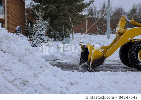 Snowplow vehicle clears snowy road during winter snowstorm 84847542