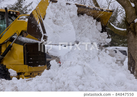 Snowplow vehicle clears snowy road during winter snowstorm Snowplow vehicle clears snowy road during winter snowstorm 84847550