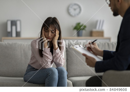 Depressed arab woman suffering from nevrous breakdown or depression, having session at psychologist's office Depressed arab woman suffering from nevrous breakdown or depression, having session at psychologist's office 84849608
