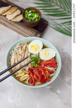 hot delicious japanese noodle soup ramen with chicken vegetables, green onions and egg with chopsticks hot delicious japanese noodle soup ramen with chicken vegetables, green onions and egg with chopsticks 84851747