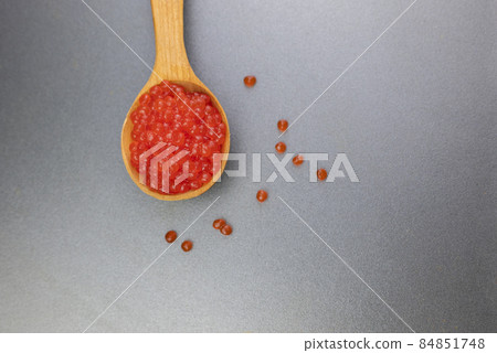 red caviar of salmon or pink salmon in a wooden spoon red caviar of salmon or pink salmon in a wooden spoon 84851748