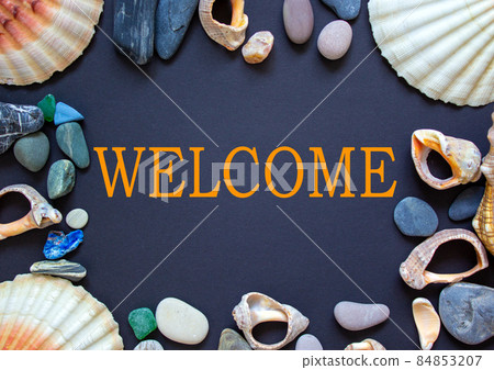 Word 'welcome' on a beautiful black background. Sea stones and seashells. Concept. 84853207