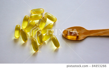 Wooden spoon with pills isolated on beautiful white background. Web banner with a copy space. 84853266