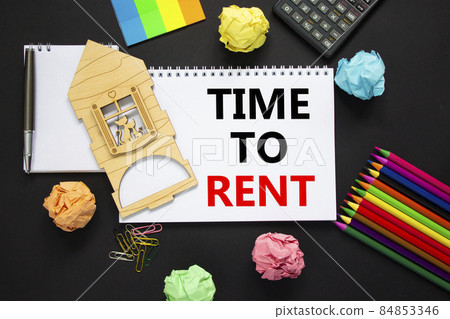 Time to rent real estate symbol. White note, words 'time to rent' on beautiful black background, metalic pen, calculator, colored pencils, miniature house. Business, time to rent real estate concept. Time to rent real estate symbol. White note, words 'time to rent' on beautiful black background, metalic pen, calculator, colored pencils, miniature house. Business, time to rent real estate concept. 84853346