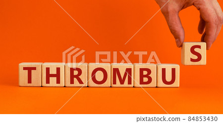 Medical and and thrombus symbol. Wooden cubes with the word 'thrombus'. Beautiful orange background. Doctor hand. Medical and thrombus concept. Copy space. Medical and and thrombus symbol. Wooden cubes with the word 'thrombus'. Beautiful orange background. Doctor hand. Medical and thrombus concept. Copy space. 84853430