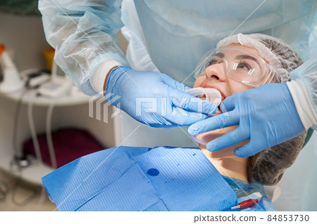 Dentist use rubber extender for a patient in modern dental clinic Dentist use rubber extender for a patient in modern dental clinic 84853730