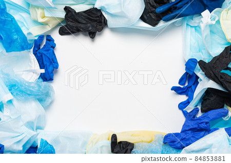 Waste of used personal protective equipment PPE gloves, disposable masks, shoe covers of medical workers in the form of a background. Garbage contamination after the COVID-19 pandemic 84853881