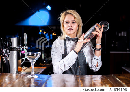 Girl bartender creates a cocktail in the pothouse Girl bartender creates a cocktail in the pothouse 84854198