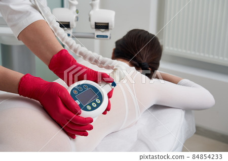 Beautiful woman getting beauty cellulite therapy Beautiful woman getting beauty cellulite therapy 84854233