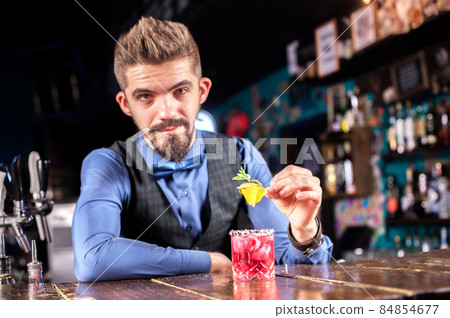 Professional bartending mixes a cocktail in pub Professional bartending mixes a cocktail in pub 84854677