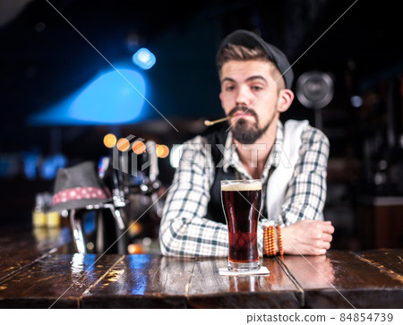 Portrait of barman mixes a cocktail in the nightclub Portrait of barman mixes a cocktail in the nightclub 84854739