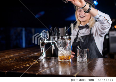 Girl barman formulates a cocktail in the brasserie 84854745