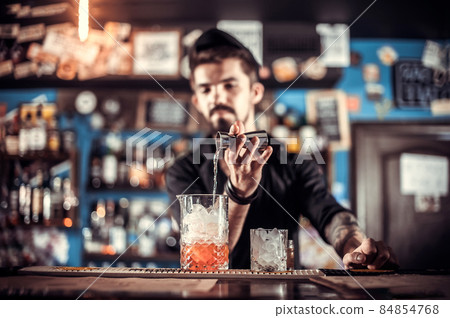 Barman creates a cocktail on the saloon Barman creates a cocktail on the saloon 84854768
