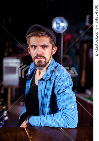 Bearded bartender makes a cocktail behind the bar Bearded bartender makes a cocktail behind the bar 84854900