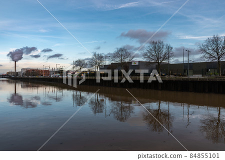 Brussels, Belgium- 12 11 2021:Reflecting industry and industrial chimney reflecting in the canal Brussels, Belgium- 12 11 2021:Reflecting industry and industrial chimney reflecting in the canal 84855101