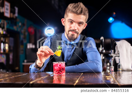 Bartender creates a cocktail at the alehouse Bartender creates a cocktail at the alehouse 84855316