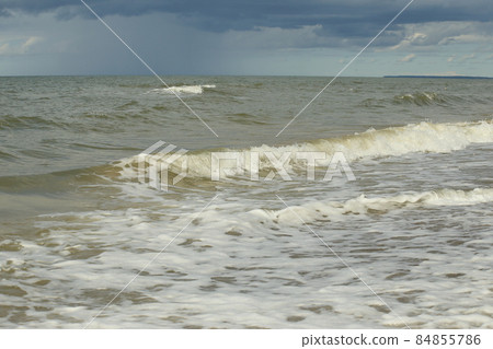 The Baltic Sea in August. Sand,seaweed on the shore, waves, beautiful clouds and the sun. High quality photo The Baltic Sea in August. Sand,seaweed on the shore, waves, beautiful clouds and the sun. High quality photo 84855786