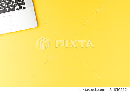 Elegant laptop on yellow table. Office desktop 84856312