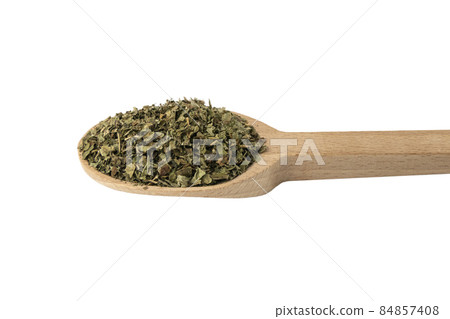 Dried Lemon balm (Melissa officinalis) herb on wooden spoon isolated on white background. 84857408