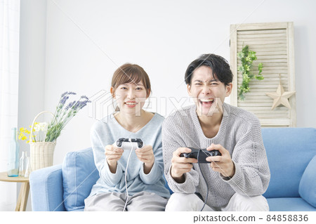 Living room for men and women playing video games Living room for men and women playing video games 84858836