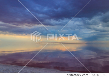 Dark storm clouds over a salt lake before a rain Dark storm clouds over a salt lake before a rain 84861199