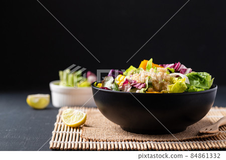 Fresh organic vegetables salad with quinoa seed in bowl on black background, Healthy Vegan food Fresh organic vegetables salad with quinoa seed in bowl on black background, Healthy Vegan food 84861332