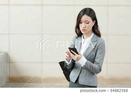 Female Entrepreneur Answering Text Messages Female Entrepreneur Answering Text Messages 84862568