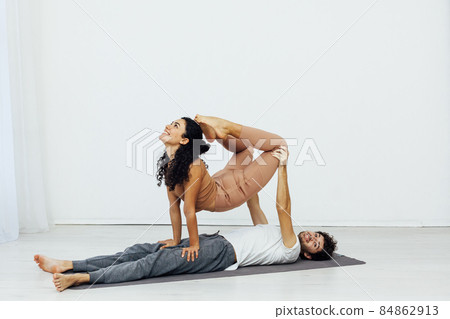 man and woman together doing exercises yoga asana fitness 84862913