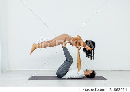 man and woman together doing exercises yoga asana fitness 84862914