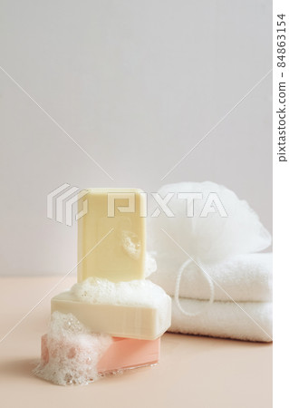 Natural organic handmade soap with large bubbles foam washcloth pastel background. Concept of using natural products Natural organic handmade soap with large bubbles foam washcloth pastel background. Concept of using natural products 84863154