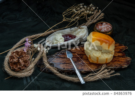 Scones on the wooden tray served with Homemade raspberry jam and Mascarpone cheese on Shell. 84863976